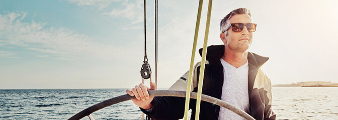 Travel, sailing and man on yacht at helm for direction on holiday, vacation and journey....