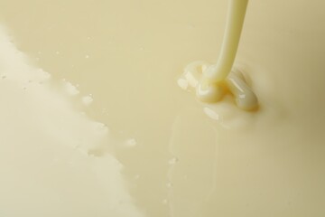 Pouring delicious condensed milk as background, closeup