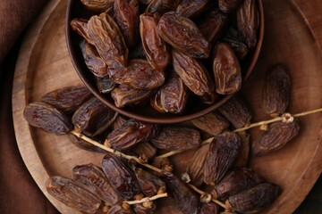 Tasty dried dates on wooden table, top view