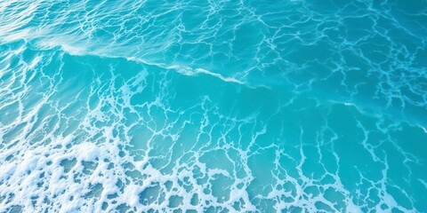 Obraz premium Beautiful turquoise ocean water with foamy waves crashing against the shore, tranquil, foam, turquoise