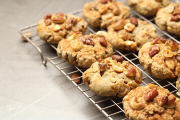 Tasty cookies with nuts on gray textured table, closeup
