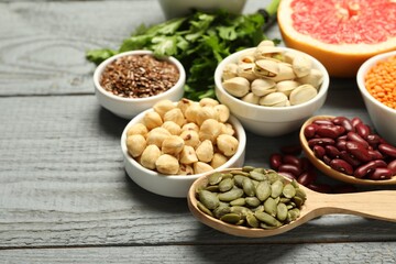 Superfood. Different healthy food products on grey wooden table, closeup. Space for text