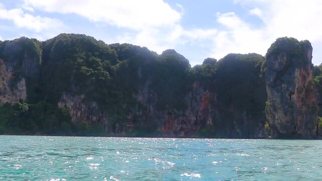 Go by boat trip limestone cliffs and turquoise waters Thailand.
