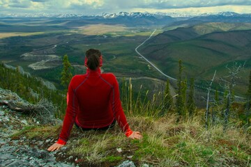 girl enjoying view to the nature and dempster highway yukon