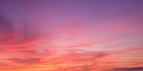 Fototapeta premium Vibrant hues of orange, pink, and purple streak across the sky at sunset, creating an abstract and mesmerizing scene, evening, dusk, orange