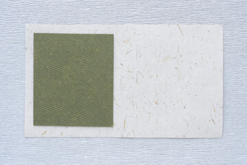 abstract paper background featuring green paper tile on seed and crepe paper