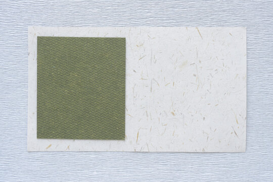 abstract paper background featuring green paper tile on seed and crepe paper
