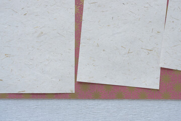 paper background featuring sheets with seed or natural elements on paper with stars or snowflakes
