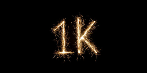 Word 1k made from sparks on a black background