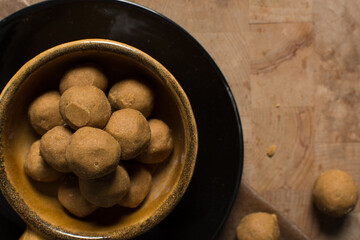 Top view of donkwa in a brown clay bowl, Overhead view of nigerian spicy donkwa, flatlay of tanfiri or groundnut cake in a bowl