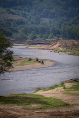 the tourist ride atv along urban road beside the river pass elephant sanctuary mae taeng chiangmai thailand