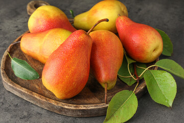 Ripe juicy pears on grey table, closeup