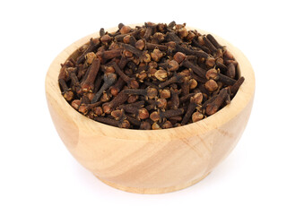 Dry clove buds in wooden bowl on white background. Aromatic spice