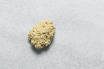 Overhead view of homemade pasta dough, top view pasta dough on a white granite countertop, process of making pasta and egg noodles