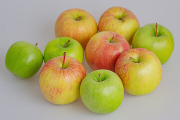 Red and green apples on a gray background thin focus part. Fruit, apple.