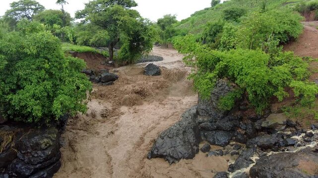 Tilt shot of muddy raging flood waters in Southern Ethiopia between Konso and Arba Minch.