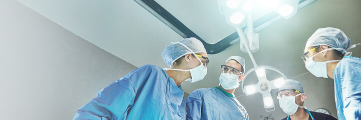 Hospital, surgery and team of doctors in operation for emergency crisis, medical service and procedure. Healthcare, discussion and surgeons with patient pov for injury, wellness and ICU treatment