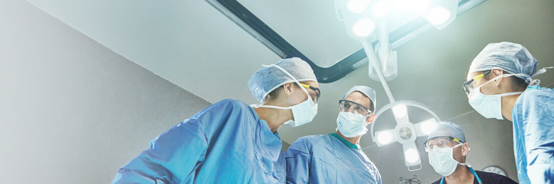 Hospital, surgery and team of doctors in operation for emergency crisis, medical service and procedure. Healthcare, discussion and surgeons with patient pov for injury, wellness and ICU treatment