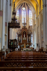 Fototapeta premium Majestic Church Interior with Ornate Altar and Stained Glass Windows
