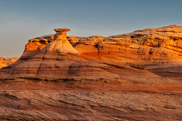 A hoodoo formation surrounded by sandstone shapes along the Beehive Trail near Page, Arizona.
