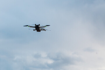 drone flying in cloudy blue sky, copy space.