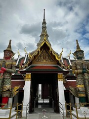 Naklejka premium Statues stand guard before a passageway (Grand Temple, Bangkok, Thailand)