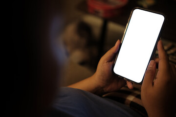 Close up view of hands holding a smartphone with a blank white screen.