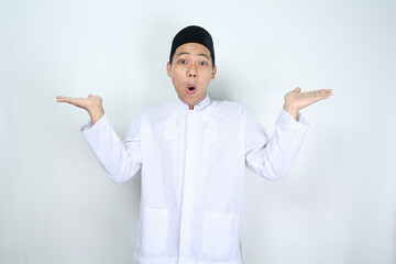 shocked asian man muslim raising hand two side to presenting copy space isolated on white background