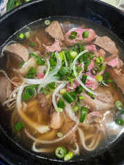 A bowl of beef pho soup.