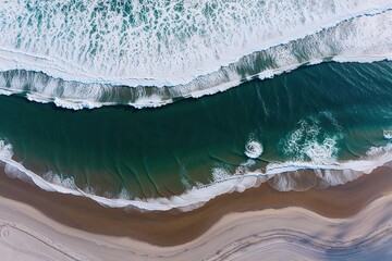 Fototapeta premium Stunning Aerial View of a Scenic Beach with Navy Waves and Soft Powdered Sand