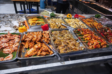 The street market offers a wide range of fresh meat for barbecue