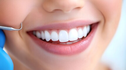 Fototapeta premium Child smiles brightly while receiving orthodontic care in a dental clinic. The orthodontist uses a tool to check the child's teeth, highlighting the importance of dental hygiene and braces.