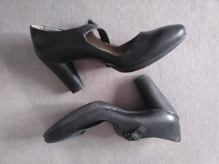 These stylish black leather high heel shoes come with a graceful ankle strap, providing both elegance and comfort. Perfect for formal occasions or a night out, they elevate any outfit.