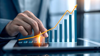 Close up of a managers hand pointing at growth charts on a tablet concept as A close up shot of a managers hand pointing at growth charts on a tablet emphasizing data driven decision making for busine