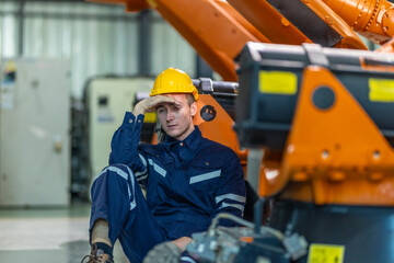 Stressed Factory Worker Resting on the Floor