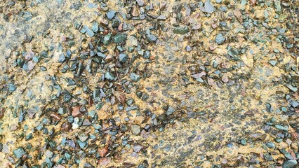 small stone background attached to yellow cement. Stone background picture arranged together.