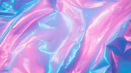 Shiny holographic wrinkled plastic film or foil. Abstract background. Pink, purple and blue light pastel colors, gloss.