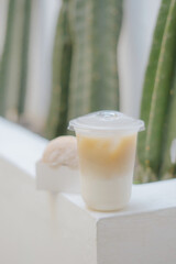 A refreshing iced coffee drink alongside some pastries, perfect for a cafe or breakfast setting. Taken with a shallow depth of field for a modern look.