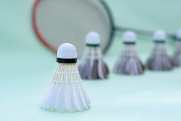 Badminton shuttlecock and badminton rackets for badminton sport playing placed on floor, soft focus, concept for endurance sport and relaxation with sport of people around the world.