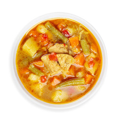 Vegetable soup with chicken, top view, on a white background, isolated.