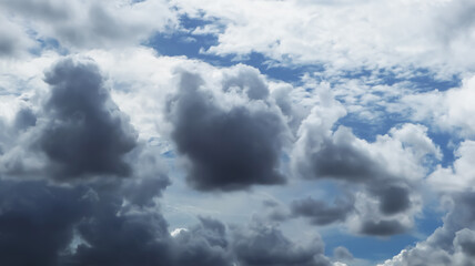 Image of storm clouds from aircraft show different shapes of clouds on the background of blue sky.