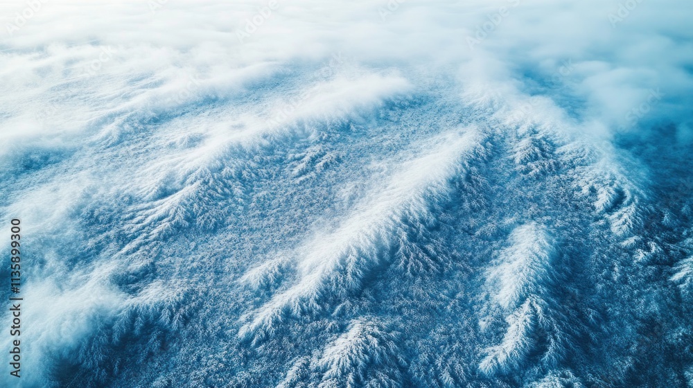 Poster aerial view of snow-covered mountains beneath a blanket of clouds.