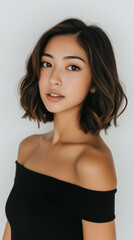 Beautiful woman with bob cut hair posing in front of white background