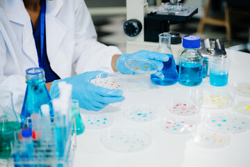 Young scientists conducting research investigations in a medical laboratory, a researcher in the foreground