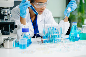 female scientist working with micro pipettes analyzing biochemical samples, advanced science chemical laboratory