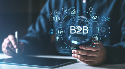Digital B2B technology concept with icons and businessman holding mobile device and stylus on a...