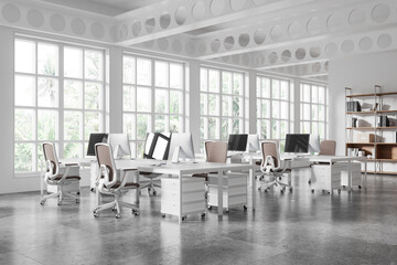 Modern coworking office space with desks and chairs, bright interior, large windows, and tropical outside view. Concept of business workspaces. 3D Rendering