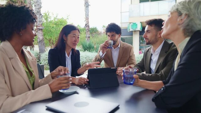 Business, multiethnic, people, financial Business people having a work meeting at a cafe table outside