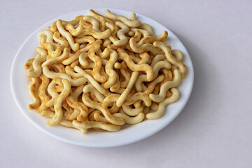 Crunchy organic mini crackers served on a white plate