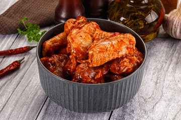 Raw marinated buffalo chicken wings